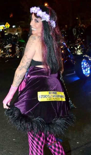 girl wearing our motorcycle awareness bumper sticker on her behind at a motorcycle event