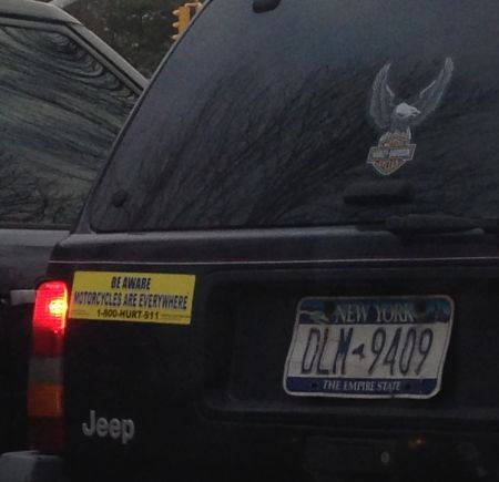 bumper sticker on an SUV