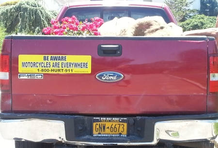 large magnetic BE AWARE MOTORCYCLES ARE EVERYWHERE® sign on a pickup truck
